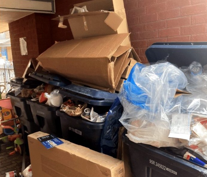 Boxes, bags and bins piled up outside a building