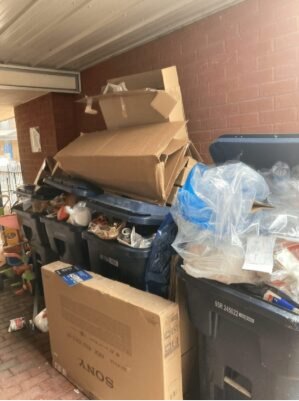 Garbage and boxes piled outside a building