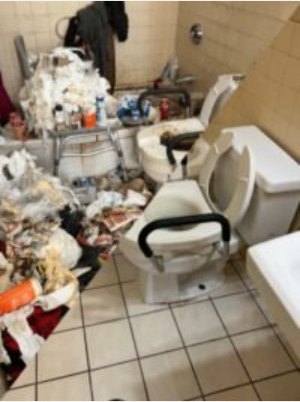 Bathroom filled with clutter before a hoarding cleanup